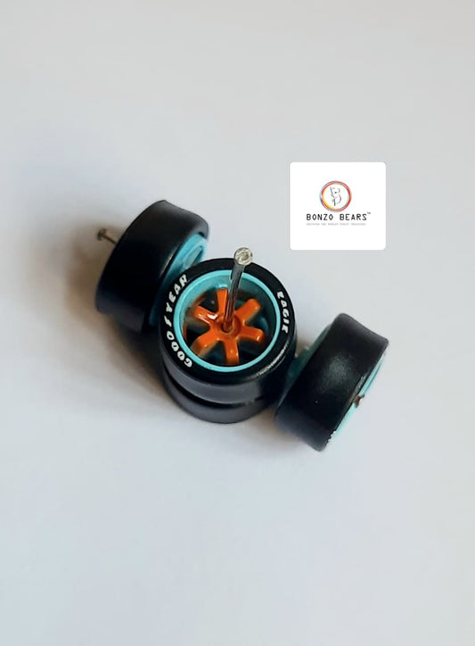 Rubber Tyre - 10mm Blue Rim Orange 6 spoke with Goodyear Eagle - 25mm axle Cv1